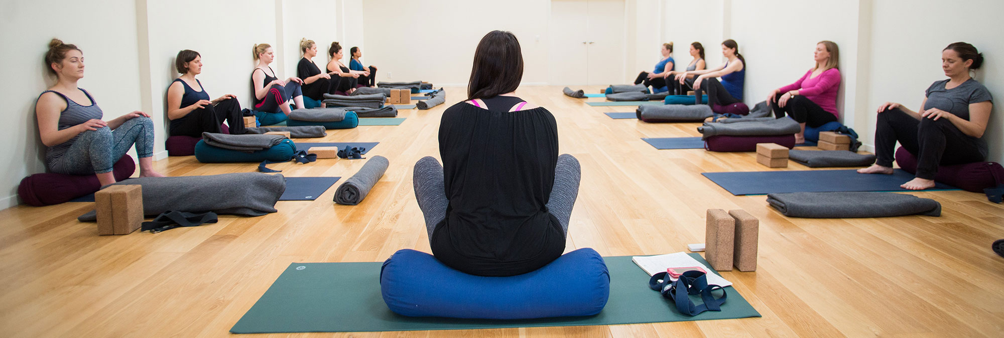 Yoga teacher with prenatal yoga class